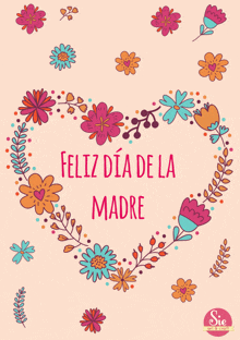 a heart shaped wreath of flowers with the words feliz dia de la madre