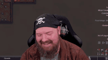 a man wearing a bandana with a skull and crossbones on it is smiling
