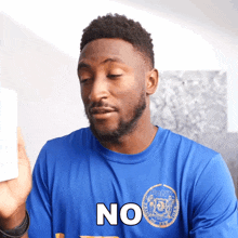 a man in a blue shirt that says no on it