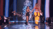 a group of women are walking down a runway .