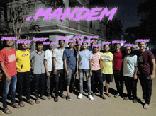 a group of young men are posing for a picture with the word mandem written in pink
