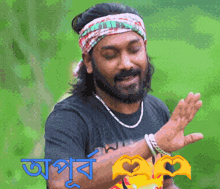 a man with a beard wearing a headband and a necklace with a heart in his hand