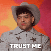 a man wearing a cowboy hat and a jacket says trust me