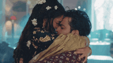 a man and a woman are hugging each other