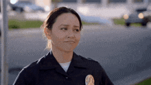 a woman in a police uniform has a patch on her chest that says ' l.a. police '