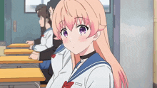 a girl with pink hair is sitting in a classroom with other students
