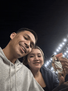 a man and woman are posing for a picture together