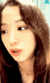 a close up of a woman 's face with a vlive logo on the bottom