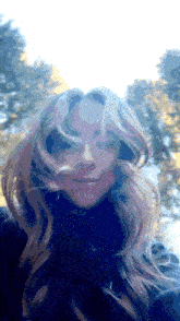 a woman 's hair is blowing in the wind and she is wearing a black turtleneck
