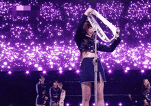 a woman is holding a sash that says miss london on it