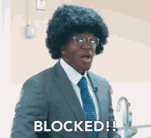 A man in a suit and tie saying Blocked