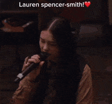 a close up of a woman 's face with the words lauren spencer-smith written above her .