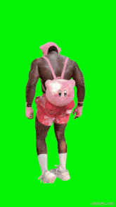 a man in pink shorts and a pink hat flexes his muscles