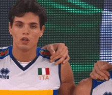 a man wearing a jersey that says ita on the front