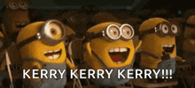 a group of minions are standing next to each other and laughing while wearing goggles .