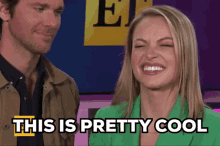 a man and woman are laughing and the woman says " this is pretty cool "