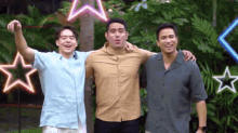 three men are posing for a picture together with neon stars behind them