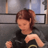 a woman wearing a black shirt that says 4/6 on it