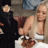 a woman is eating from a styrofoam container while a cartoon character looks on