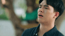 a young man in a black shirt is crying