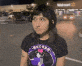 a woman standing in front of a walmart