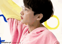 a gif of a person wearing glasses and a pink shirt with the hashtag atthaphan gif