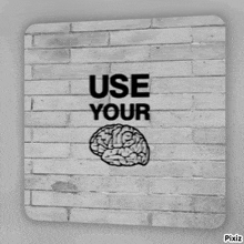 a brick wall with a drawing of a brain and the words " use your "