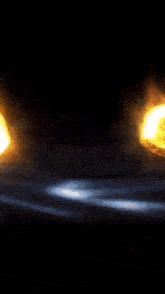 a close up of a glowing object in the dark with a black background