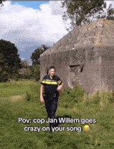 a man in a police uniform is walking in a field with the caption " pov cop jan willem goes crazy on your song " below him