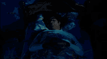 a man wearing glasses is sleeping in a bed with a disney pillow