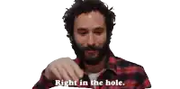 a man in a plaid shirt is saying right in the hole