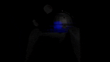 a red light is shining on a black object in the dark