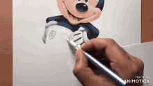 a person is drawing a picture of mickey mouse with a pencil