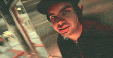 a man in a dark room with a red light behind him