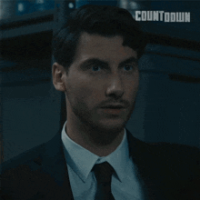 a man in a suit and tie with the word countdown on the bottom