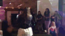 a blurry picture of a group of people dancing in a dark room
