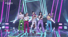 a group of girls are dancing on a stage and the words honeycam.org are on the bottom of the screen