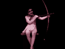 a naked cupid is holding a bow and arrow in a black and white photo .