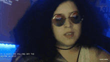 a woman wearing sunglasses says her glasses are falling off