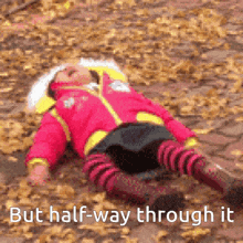 a girl in a pink jacket is laying on the ground with the words but half-way through it below her
