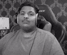 a black and white photo of a man wearing headphones and a shirt that says cer