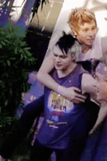 a man in a purple shirt that says raven on it