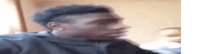 a man with a mohawk is making a funny face in a room .