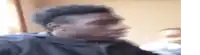 a man with a mohawk is making a funny face in a room .