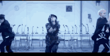 a group of people are dancing in a room with microphones