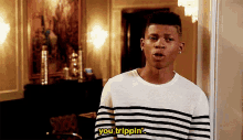 a man wearing a striped shirt says you trippin '