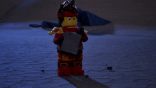 a lego figure is holding a briefcase and a hammer