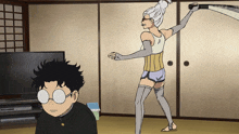 a boy wearing glasses looks at a woman holding a whip in a living room