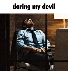 a man sitting in a chair with the words daring my devil written above him