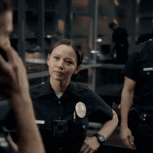 a female police officer with a badge that says l.a.p.d. on it